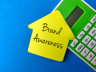 Top view calculator and colored sticky notes with the word BrandcAwareness