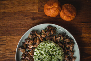 Beef and rice with spinach prepared meal in plate on the table ready to eat