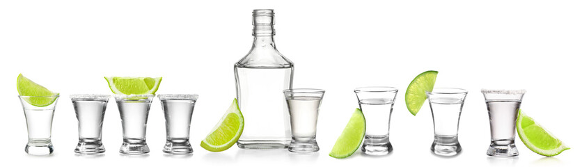 Set with shots and bottle of tasty tequila with lime on white background