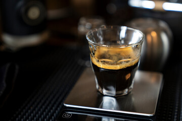Espresso shot coffee by barista in a glass cup on table in vintage color with blank copy space