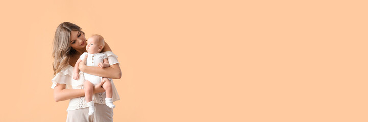 Happy mother with cute little baby on color background with space for text