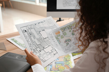 Young female landscape designer working in office
