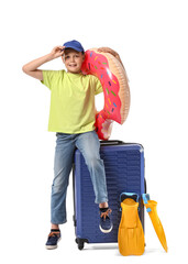 Cute little boy with suitcase, inflatable ring and paddles on white background