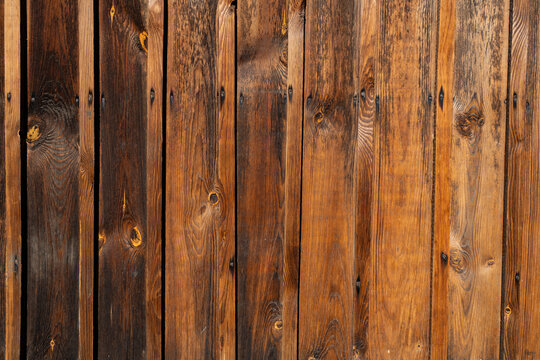 Wodden brown planks in various shades of colours, aged wodden wall of the cottage house surface making a good background material