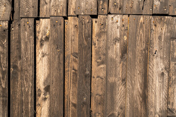 Wodden brown planks in various shades of colours, aged wodden wall of the cottage house surface making a good background material