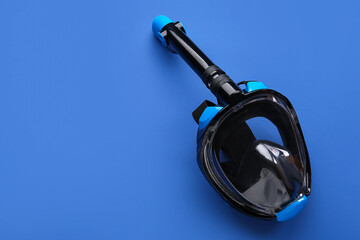 Modern snorkeling mask on blue background