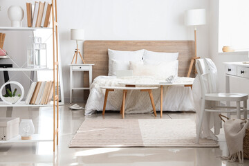 Interior of bedroom with modern furniture near white wall