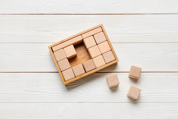 Cubes on white wooden background, top view