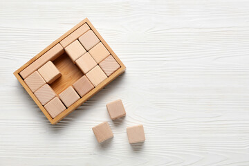 Cubes on white wooden background, top view
