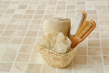 Basket with bath supplies on color tile