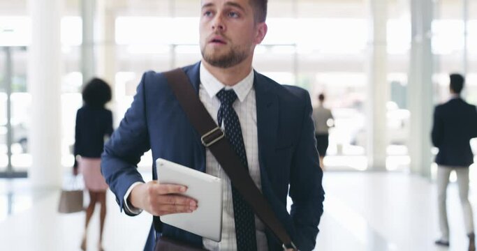I hope I make it in time. 4k video footage of a businessman checking his digital tablet while running in an office building.