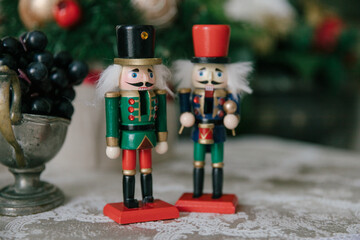 Bright figures of tin soldiers made of wood stand on the table in front of the Christmas tree.A New...