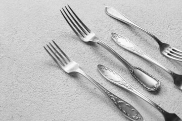 Silver forks on light background