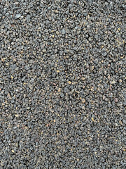 Dark grungy gravel packed into a pathway.
