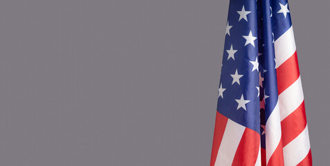 The American flag is on the right side on a gray background