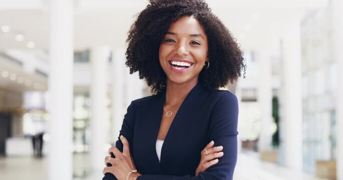 Let nothing overtake your determination to be your best. Beautiful confident happy young multi ethnic business woman standing alone with her arms crossed and smiling positively in a modern workspace