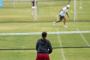 Amateur playing tennis at a tournament and match on grass in Melbourne, Australia 