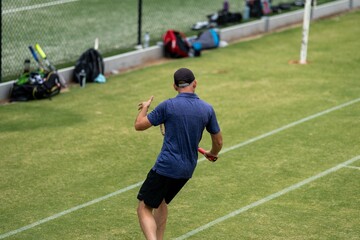 Amateur playing tennis at a tournament and match on grass in Melbourne, Australia 