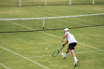 Amateur playing tennis at a tournament and match on grass in Melbourne, Australia 