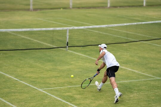 Amateur Playing Tennis At A Tournament And Match On Grass In Melbourne, Australia 