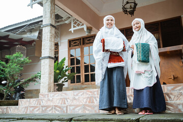muslim mother and daughter getting ready to do idul fitri prayer together