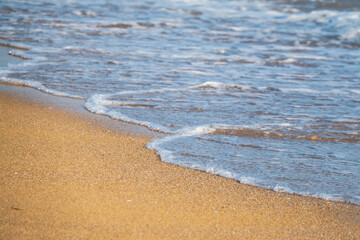 Soft wave of the sea on the sandy beach.