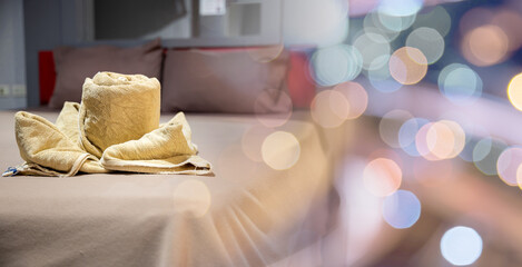 Yellow towel on bed decoration in bedroom interior, Freshly laundered fluffy towels, Towel in hotel room, Beautifully folded toiletries