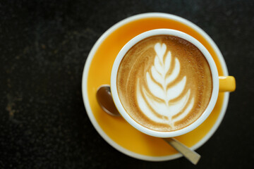 Coffee Latte leaf pattern face on black table