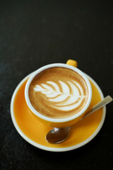 Coffee Latte leaf pattern face on black table