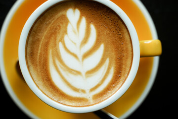 Coffee Latte leaf pattern face on black table