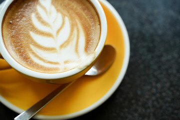 Coffee Latte leaf pattern face on black table