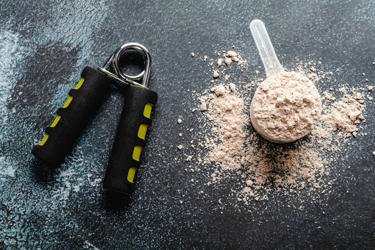 Scoops filled with protein powders for fitness nutrition to start training
