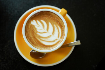 Coffee Latte leaf pattern face on black table