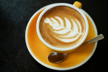 Coffee Latte leaf pattern face on black table