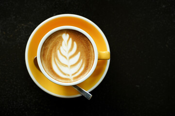 Coffee Latte leaf pattern face on black table
