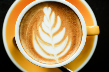 Coffee Latte leaf pattern face on black table