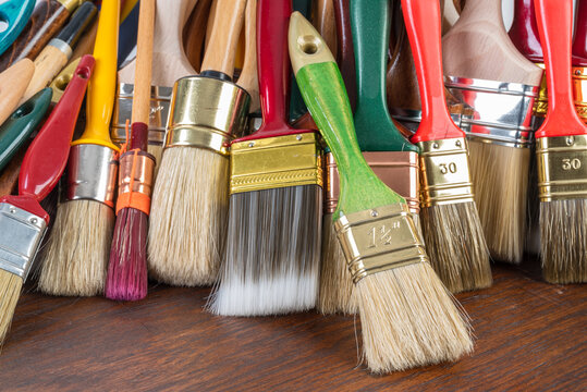 Close-up Set of Paint Brushes on Wooden Table