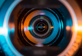Fototapeta Video camera lens lit by blue and orange color light obraz