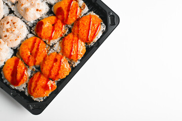 Japanese traditional food, baked yakimaki rolls delivery on white table top view. Asian cuisine. Close-up, flat lay