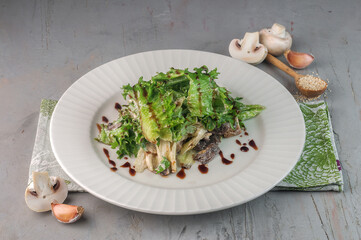 green salad with mushroom on gray background