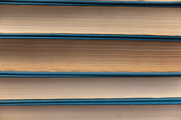 Texture Stacks of old books. Blue hardcover books