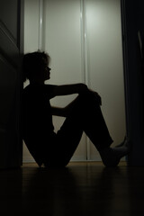 silhouette of a person in a door arch