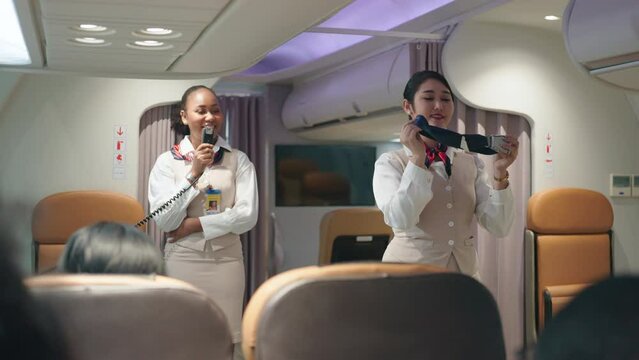 Air hostesses are demonstrating how to use the equipment on board passenger planes.