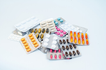 Tablets and medical capsules in a blister pack isolated on white background
