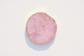 Pink marble podium for product presentation on white background. Empty cylindrical platform for cosmetic. Mockup with cstone circle and copy space.