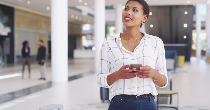 Find a better way to do it...and do it. 4k video footage of a young businesswoman using a smartphone and looking thoughtful in a modern office.
