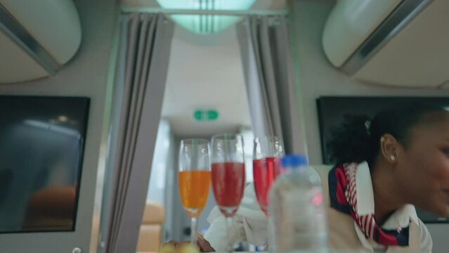 Flight attendants prepare food and drink for passengers.