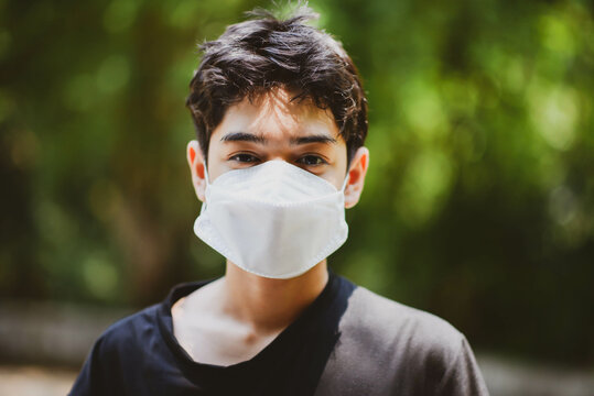 Close Up Of Teenager Boy  Wearing Mask With Smile