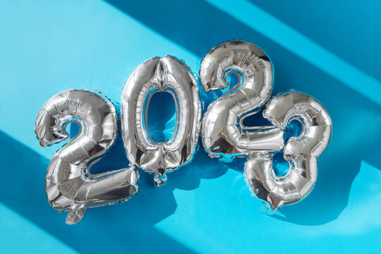 Happy New year 2023 celebration sunshine's bright light. Silver balloons figures, New Year Balloons Christmas and new year celebration. Silver foil balloons 2023