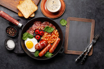 English breakfast with fried eggs, beans, bacon and sausages